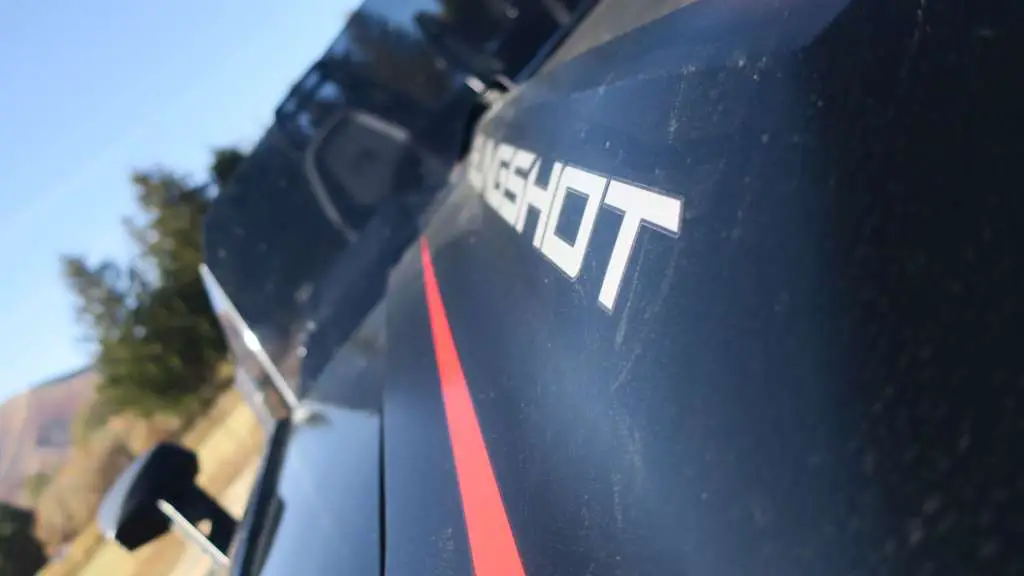 Edgy close-up of the Slingshot emblem on the hood.