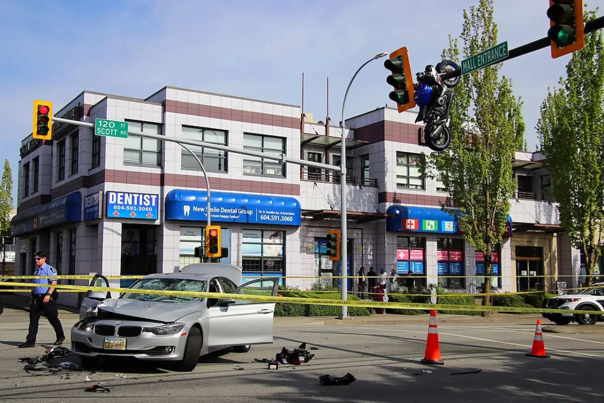 Photos show the motorcycle suspended above the roadway from an overhead traffic signal pole following the crash.